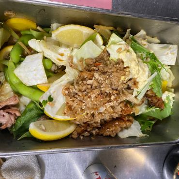 炭焼雷の食品ロス調査で記録した、お客様が食べきれずに残された料理。野菜やレモンなどが皿に残っている様子。